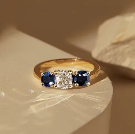 1+1 Offer: Golden Three Stone Cushion Cut White & Blue Sapphire Wedding Band Ring for Women + Round Cut White Sapphire Gold Necklace - Image 3